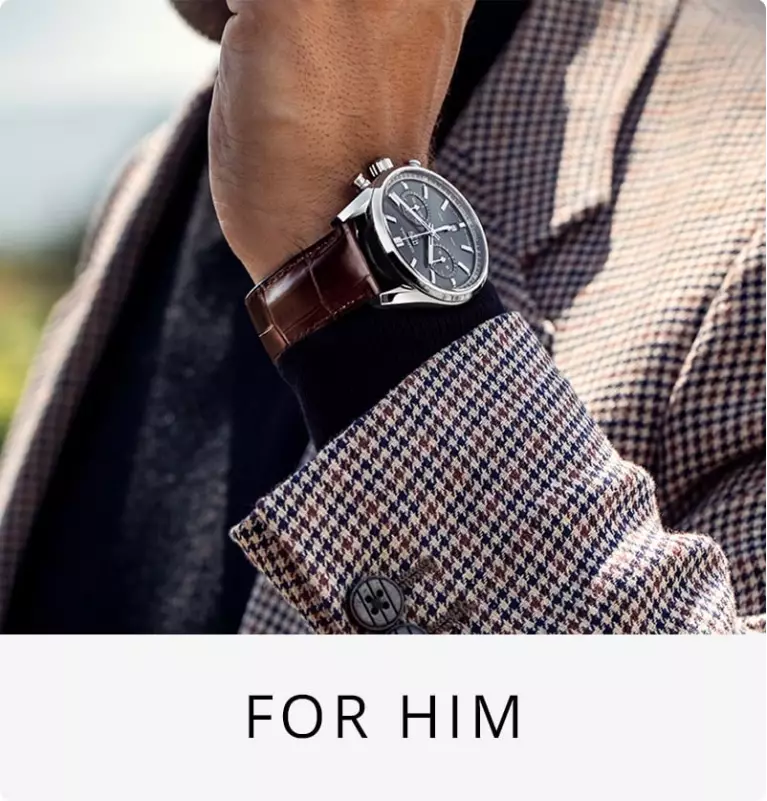 A man in a suit modelling a watch