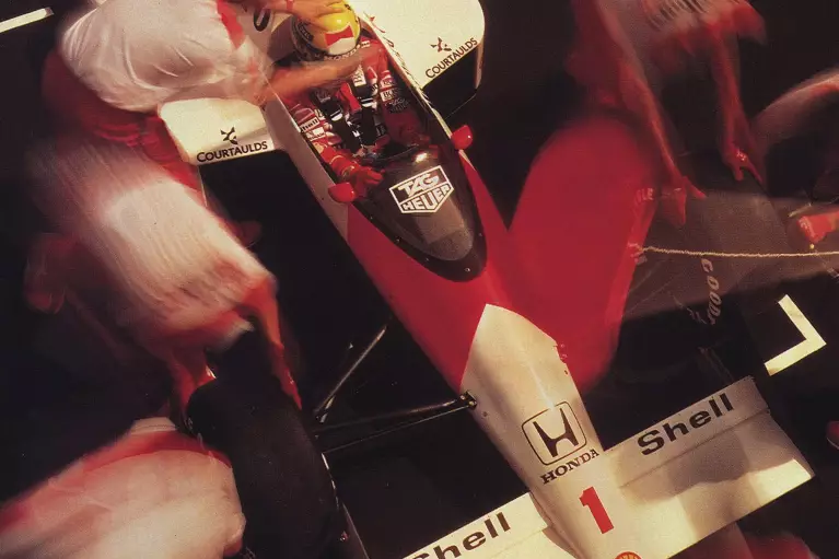 The Mclaren team in 1985 working on their car during a Formula 1 race