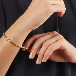 FOPE Eka Tiny Yellwo Gold Flex'it Bracelet with Diamond Pave close up on model