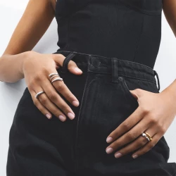 Georg Jensen Mercy Twist Ring lifestyle photo of women in black jeans and top wearing Georg Jensen Mercy ring