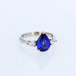 Pear cut tanzanite and diamond white gold ring with yellow gold setting front view