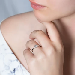 Platinum Emerald & Taper Cut Diamond Ring on model