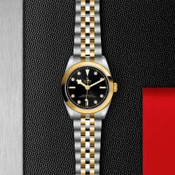 TUDOR Black Bay 31 S&G 31mm Black Dial on a steel and yellow gold bracelet on a branded background