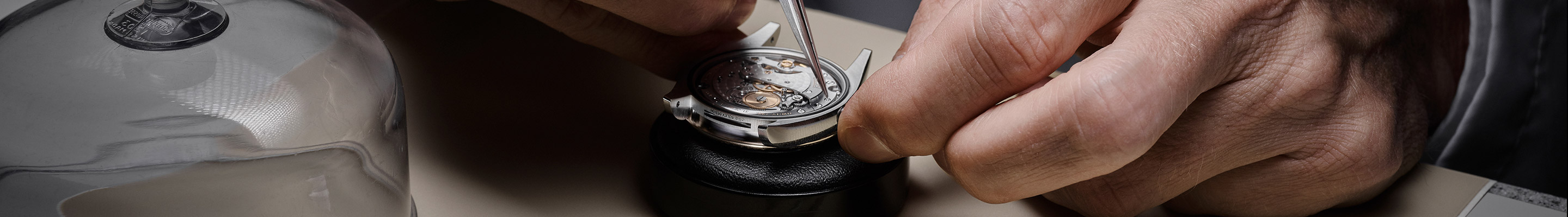 The open caseback of a Rolex watch being serviced